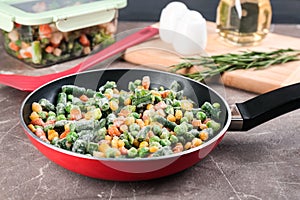 Tasty frozen vegetable mix on brown table