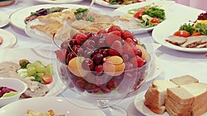 Tasty fruit - peaches, cherries, cherry on table.