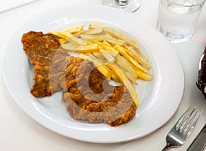 Tasty frying pork escalope served at plate with french fries