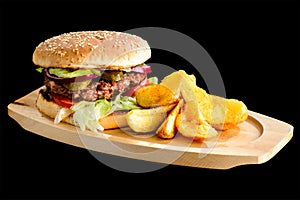 Tasty Gamburger with beef meat, tomato, pickes and potato wedges