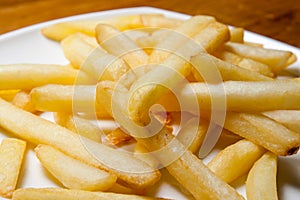 Tasty golden french fries on a plate.