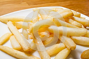 Tasty golden french fries on a plate.