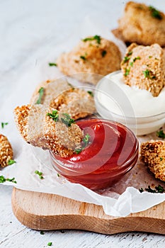 Tasty golden nuggets with red and white sauces