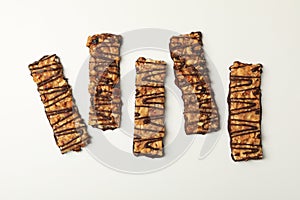 Tasty granola bars on white background top view