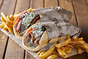 Tasty greek gyros with fries with feta cheese and tzattziki sauce