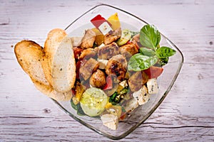 Tasty Greek salad on plate laid on table, Greek national dish