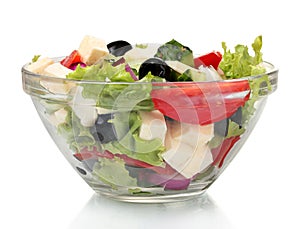 Tasty greek salad in transparent bowl