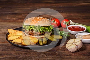 Tasty grilled homemade burger with beef, tomato, cheese, cucumber and lettuce