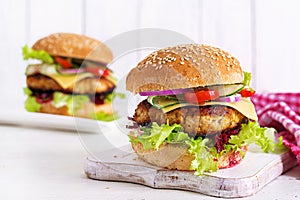 Tasty grilled homemade hamburger with burger chicken, tomato, cheese