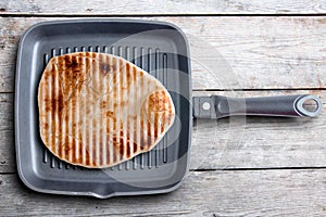 Tasty Grilled Naan Flatbread on a Square Pan photo