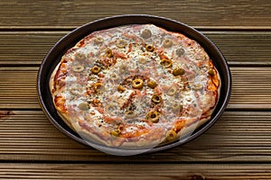 A tasty ham pizza with green olives