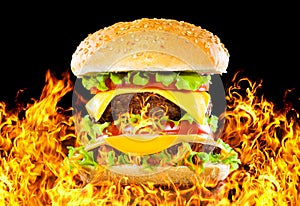 Tasty hamburger on fire on a dark