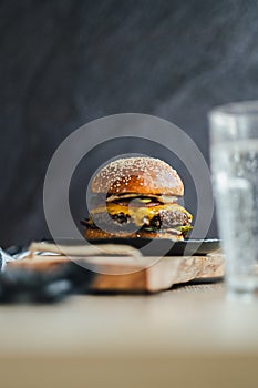 Tasty hamburger with melted cheese and the sesame on the top of the bun