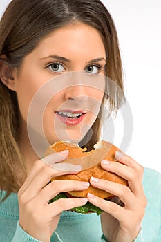 Tasty hamburger - woman enjoying fast food