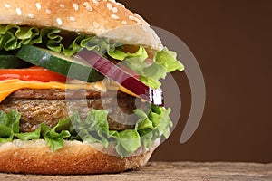 Tasty hamburger on wood background