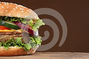 Tasty hamburger on wood background.