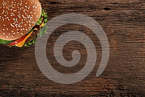 Tasty hamburger on wood background.