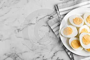 Tasty hard boiled eggs on white table, flat lay. Space for text