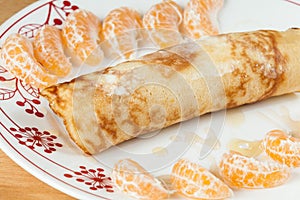 Tasty And Healthy Breakfast; Rolled Pancakes With Honey And Tangerine