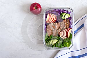 Tasty healthy lunch of vegetables and baked turkey. Salad of red cabbage, spinach, apples, fresh cucumbers with diet meat in a