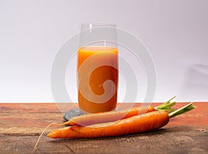 Tasty healthy natural sweet vegetable drink, fresh organic carrot juice ready to drink in glass