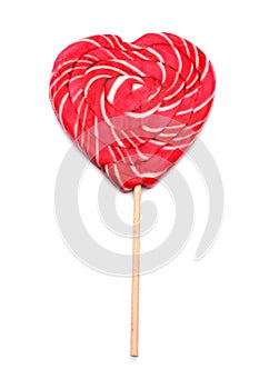 Tasty heart-shaped lollipop on white background