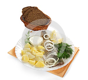 Tasty herring, potatoes with sauce and a bread