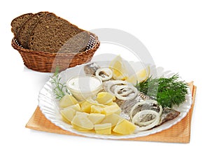 Tasty herring, potatoes with sauce and bread