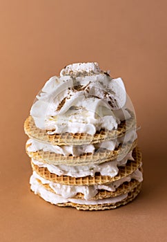 Tasty Holland Waffles with Caramel Decorated with Cream on Light Brown Background