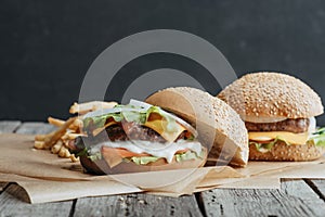 tasty homemade cheeseburgers on baking paper