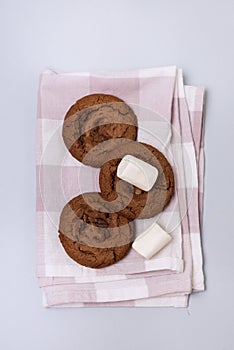 Tasty Homemade Chocolate Chip and Marshmallow Dark Chocolate Cookies Linen Napkin Blue Background Vertical