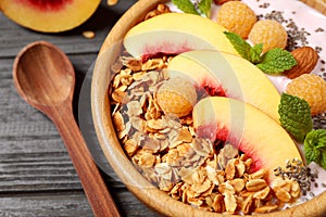 Tasty homemade granola with yogurt on wooden table, closeup. Healthy breakfast