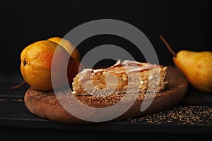 Tasty homemade pear pie on wooden background