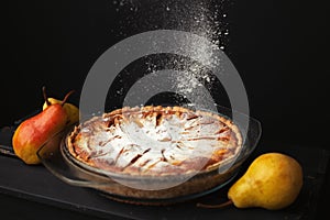 Tasty homemade pear pie on wooden background