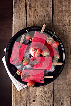 Tasty Homemade Strawberry Fruits and Chocolate Popsicle on Black Plate Wooden Background Homemade Ice Cream Summer Dessert