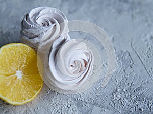 Tasty homemade zephyr with lemon flavour, grey background