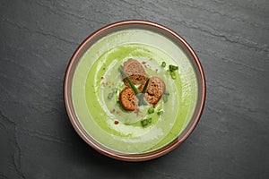 Tasty homemade zucchini cream soup on table, top view