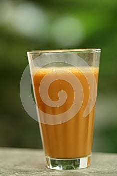 Tasty and hot milk masala tea in old glass