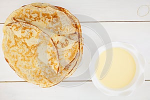 Tasty hot pancakes on plate on white table top view