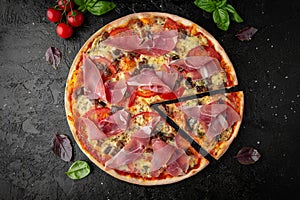 Tasty hot pizza with Bacon, Baked Pork, Tomatoes, Olives, Cheese, Feta, Mozzarella, Basil and Sauce. Pizzeria menu.