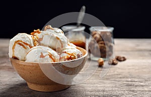 Tasty ice cream with caramel sauce and popcorn