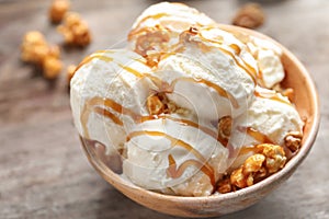 Tasty ice cream with caramel sauce and popcorn