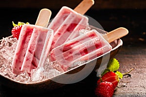 Tasty ice lolly with strawberries