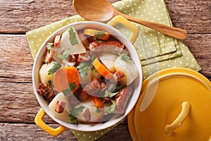Tasty Irish coddle with pork sausages, bacon and vegetables in a