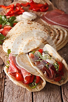 Tasty Italian piadina stuffed with ham, cheese and vegetables cl