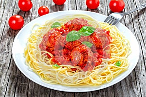 Tasty italian spahgetti with meatballs and tomato sauce, close-up