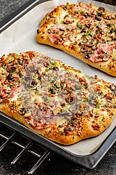 Tasty italian square pizza on kitchen table