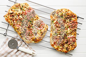 Tasty italian square pizza on kitchen table. Top view