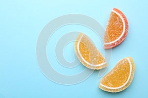 Tasty jelly candies on color background, space for text