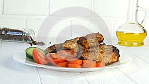 Tasty juicy fresh slices of grilled steak entrecote pork meat next to cherry tomatoes and fresh vegetables cucumbers on